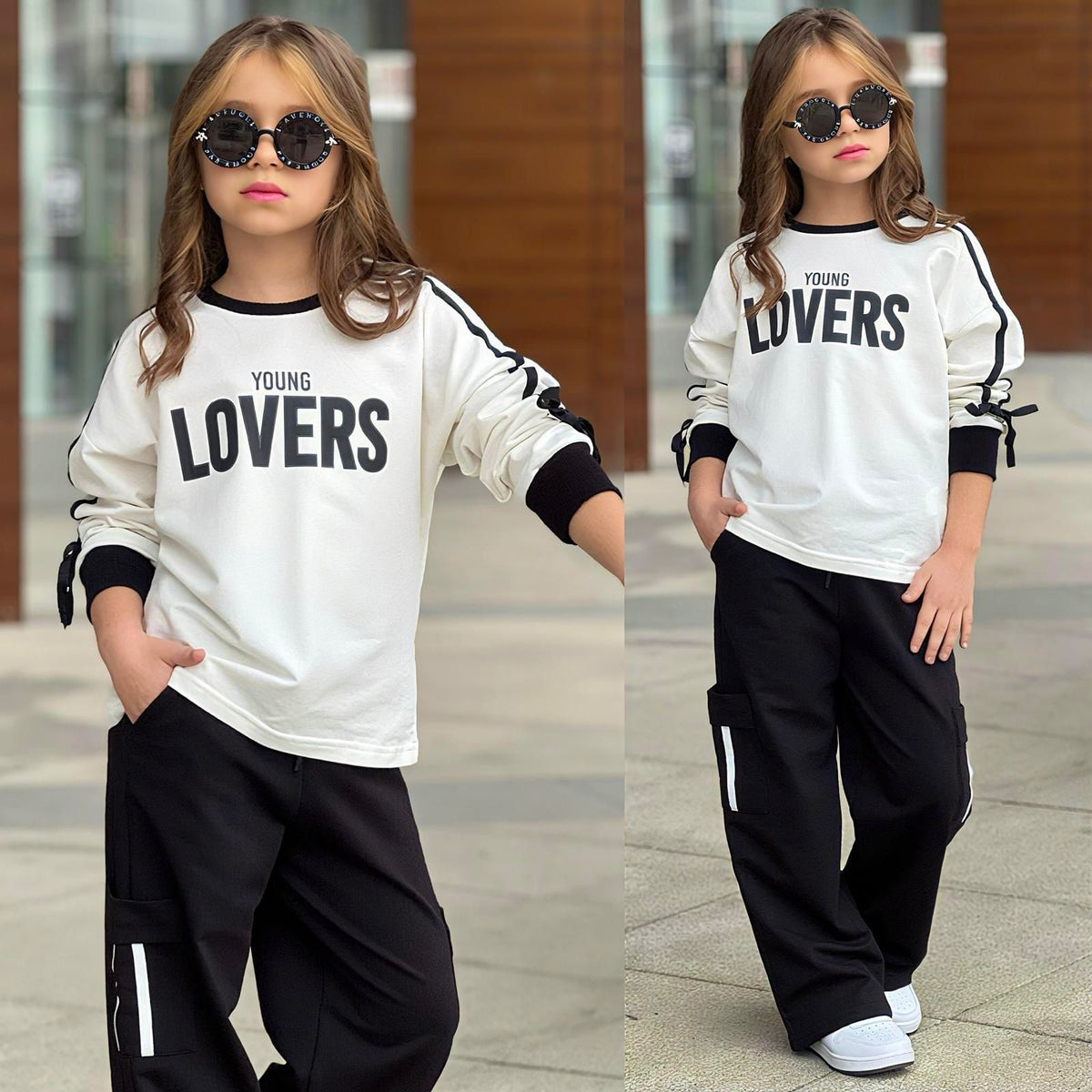 Mädchen-Set „Young Lovers" in Weiß/Schwarz – Sweatshirt mit schwarzen Streifen und Schleifenärmeln, schwarze Cargo-Hose mit weißem Seitenstreifen