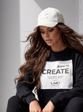 LAKI Couture Sweatshirt „Born to Create" – Gesamtansicht mit Statement-Patch