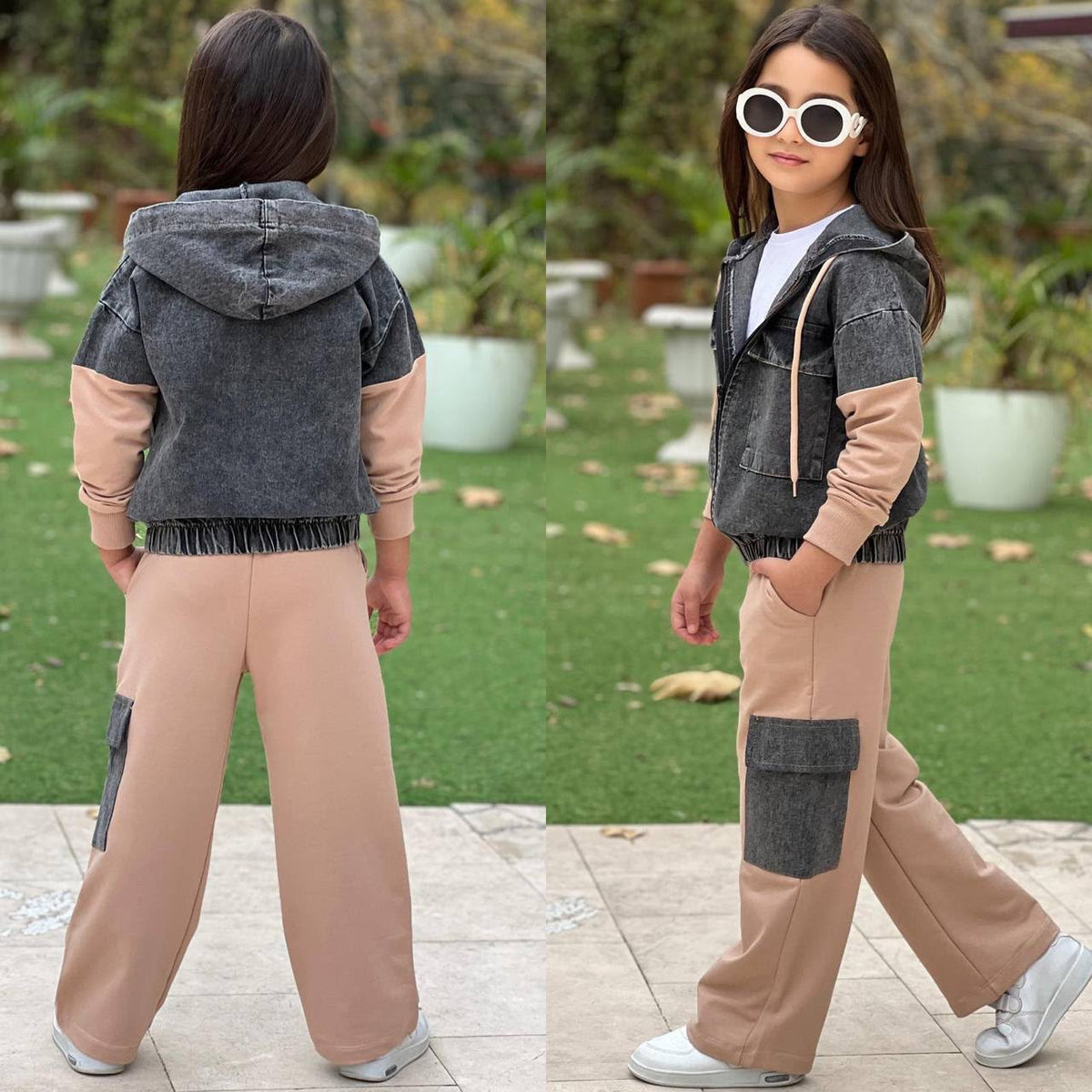 Mädchen trägt das 3-teilige Set in Beige und Anthrazit mit Kapuzenjacke, weißem T-Shirt und weiter Hose, Ansicht von vorne und hinten