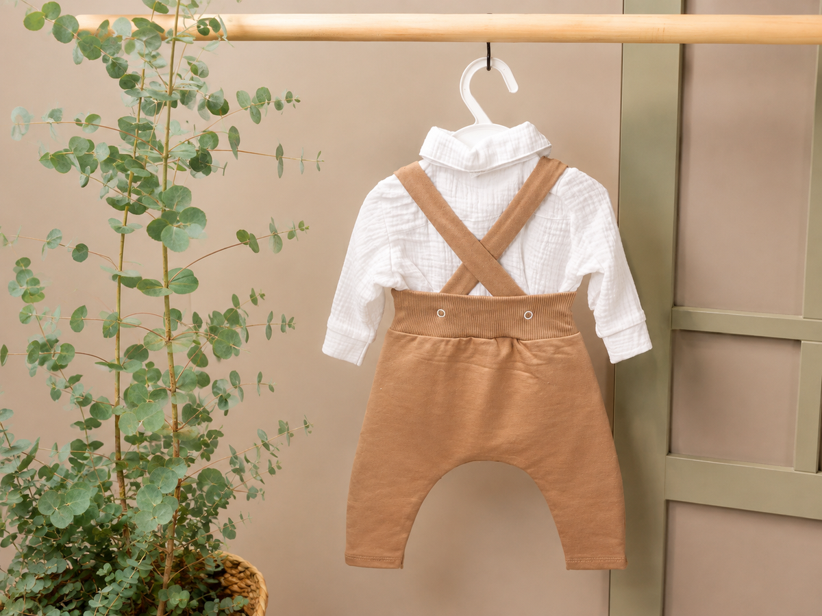 Baby-Set Musselin Body Latzhose Camel – Rückansicht, gekreuzte Träger der Latzhose und weißer Body